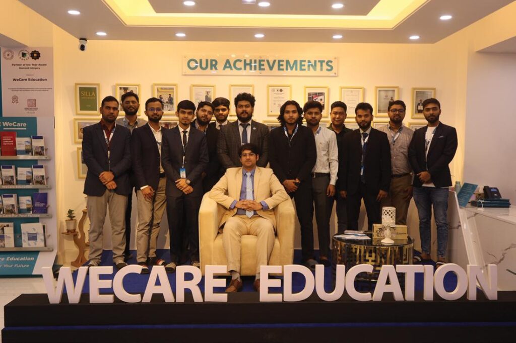 The WeCare Education team in front of the WeCare sign